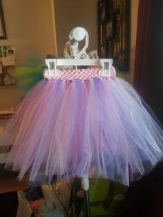 Child tutu will fit ages 1-5 2 shades of pink and 2 shades of purple combined for a fairy like tutu- pink band hangs 11" in length Price listed is for 11" length Single Layer For double layers please add $5 and contact directly to order All my items are custom made to order- To see on hand items that can be shipped the next day please visit www.facebook.com/tutusbyamber1/ Purple Tulle Tutu Dress For Birthday, Purple Princess Tutu Dress For First Birthday, Purple Fairy Style Tutu Dress, Pink Fairy Tutu Dress For Birthday, Whimsical Pink Tutu Dress, Whimsical Pink Tutu Dress With Tulle Skirt, Whimsical Pink Tulle Tutu Dress, Pink Tulle Tutu Dress For Dance, Cute Purple Tulle Tutu Dress