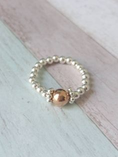 Fabulous handmade Sterling Silver & Rose Gold Filled Stretch Ring.  This ring is truely beautiful. I have matching bracelets and necklaces.  ⭐ 3mm Sterling Silver Beads  ⭐6mm Rose Gold Filled Bead ⭐Sterling Silver Daisy Spacers  Measuring your ring finger: wrap a length of cotton around the finger where you would like the ring to sit, then measure the cotton from end to end to get the circumference / size you need to order.  All of my rings and bracelets are hand threaded on high quality, strong Silver Heart Bracelet, Sterling Silver Bead Bracelet, Silver Toe Rings, Stretch Ring, Beaded Ring, Silver Bead Bracelet, Silver Stacking Rings, Gift For Her Birthday, Ring Stacking