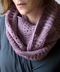 a woman wearing a purple knitted cowl with her eyes close to the camera