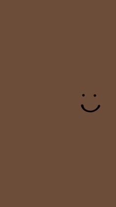 a brown square with a smiley face drawn on it's side and the bottom half of its face is black