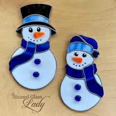 two stained glass snowmen with hats and scarves