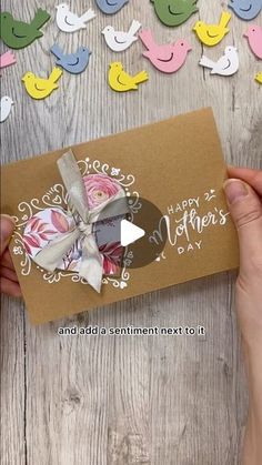 someone is holding up a card that says happy mother's day with birds on it