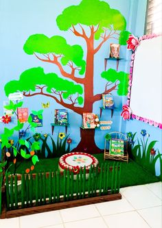 a child's playroom with a tree painted on the wall