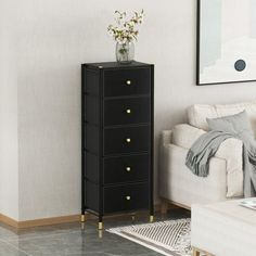 a living room with a white couch and a black chest of drawers in the corner