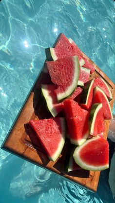 slices of watermelon on a cutting board in the pool