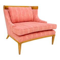 an upholstered pink chair with wooden legs and arm rests against a white background