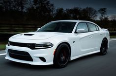 a white dodge charger driving down the road