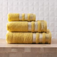 three yellow towels stacked on top of each other