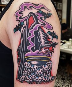 a woman with a tattoo on her arm has skulls and a skull bowl in it