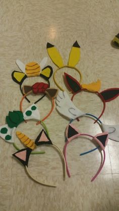 several animal ears and headbands are laid out on the floor