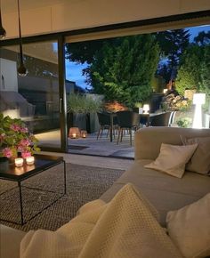 a living room filled with furniture next to a sliding glass door