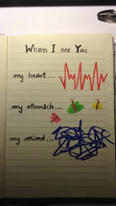 an open notebook with writing on it that says, when i see you my heart my stomach my stomach my mind