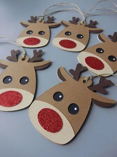 paper reindeer ornament with red nose and antlers hanging from twine string