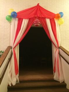 an entrance to a party with balloons on it