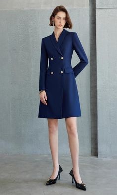 Exude Confidence with the Navy Double-Breasted Blazer Dress Step into a world of refined elegance with our Navy Double-Breasted Blazer Dress—the epitome of power dressing for the modern woman. This dress combines the sharp tailoring of a blazer with the femininity of a dress, creating a look that is both authoritative and elegant. Crafted from high-quality fabric, it features a sleek navy hue, structured shoulders, and gold-tone buttons that add a touch of luxury. The long sleeves and tailored f Structured Fitted Blazer Dress With Buttons, Elegant Structured Blazer Dress For Formal Occasions, Fitted Dresses With Double Button Closure, Notch Lapel Dress With Button Closure, Elegant Single-breasted Formal Jacket Dress, Elegant Structured Single-breasted Blazer Dress, Semi-formal Single-breasted Knee-length Blazer Dress, Classic Tailored Single Breasted Dress, Tailored Dresses With Button Closure For Work