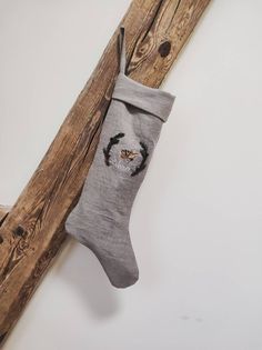 a christmas stocking hanging on a wooden pole