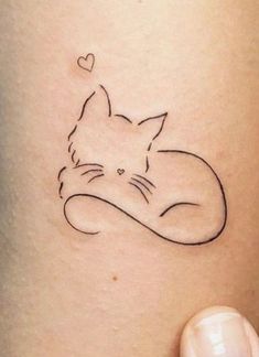 a cat tattoo with a heart on it