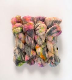 several skeins of multicolored yarn on a white surface