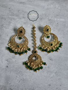 Overview Elevate your style with our stunning Green Maang Tikka and Earrings set, perfect for weddings, parties, and special occasions. This exquisite set is designed to make you feel special and stand out in any crowd. Shop now at Emro Collection! Product Features Elegant Design Our Green Maang Tikka and Earrings set features a sophisticated design that combines traditional elements with modern flair. The intricate detailing and vibrant green color make it a standout piece. High-Quality Materia Hand Set Bridal Sets For Festive Party, Green Hand-set Chandbalis For Party, Elegant Party Tikka With Hand Set Details, Hand Set Danglers For Party And Festive Occasions, Hand Set Danglers For Party And Festive Season, Hand Set Chandelier Earrings For Parties And Festivals, Diwali Party Hand Set Chandelier Earrings, Hand-set Dangle Chandbalis For Party, Hand Set Dangle Chandbalis For Party