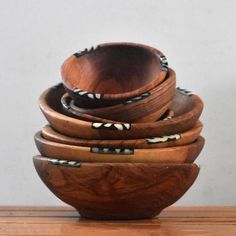 several wooden bowls stacked on top of each other