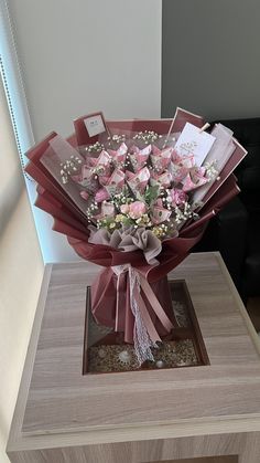 a bouquet of pink flowers sitting on top of a table