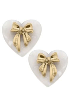 Complete your elegant look with our Cecelia Bow & Mother of Pearl Heart Stud Earrings. These stunning earrings feature a delicate bow design and a heart-shaped Mother of Pearl stone for a touch of sophistication. Perfect for any occasion, these earrings will make you stand out in style. Elegant Double Heart Earrings For Valentine's Day, Chic Heart Charm Earrings For Valentine's Day, Elegant Earrings With Heart Detail, Elegant Heart Detail Earrings For Gift, Elegant Heart-shaped Earrings For Gifts, Chic Earrings For Anniversary On Valentine's Day, Elegant Heart Pendant Earrings For Party, Elegant Heart Pendant Earrings For Formal Occasions, Heart Detail Double Heart Earrings For Gift