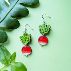 These cute radish earrings are inspired by the "Sparkler" radish or breakfast radish varieties with their distinctive vivid coloring and plump roundness. These original earrings are hand painted on cherry wood with two separate pieces, etched details, and a gorgeous ombre of bright red to white. Lightweight and cute, these radishes are a fun addition to your wardrobe and a great gift for a gardener or fan of Luna Lovegood. Option 1: Silver Ear WiresThese earrings feature silver hypoallergenic 304 stainless steel ear wires. Option 2: Gold Ear WiresThese earrings feature gold hypoallergenic 304 stainless steel ear wiresOption 3: Silver Ball PostsThese earrings feature 4mm silver-plated brass ball posts with butterfly backs.Option 4: Gold Ball PostsThese earrings feature 4mm 24k gold-plated b Radish Earrings, Kraft Gift Boxes, Luna Lovegood, Radishes, Gift Card Shop, Wooden Jewelry, Cherry Wood, Bright Red, Ear Wires