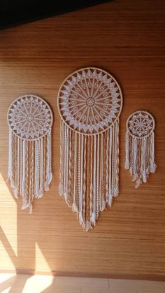 three white dream catchers hanging on the wall