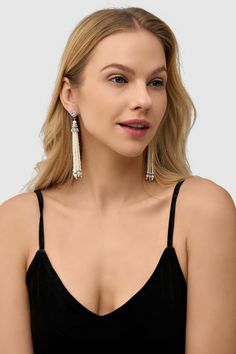 This sumptuous piece of jewelry features a retro-elegant yet slightly modern style that complements the lavish garments, reminiscent of the roaring 1920s. Features: Lustrous imitation pearls Rhinestone studded design 4.21 inch / 10.7cm long Dangling pearl tassels Elegant Metal Dangle Tassel Earrings, Elegant Metal Tassel Drop Earrings, Elegant Fringe Metal Chandelier Earrings, Elegant Metal Fringe Jewelry, Elegant Silver Tassel Earrings For Evening, Glamorous Tassel Earrings For Wedding, Elegant Metal Tassel Earrings With Fringe, Elegant Evening Tassel Drop Earrings, Elegant Formal Tassel Drop Earrings