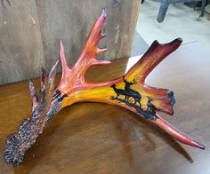 a wooden table topped with a deer head and antlers