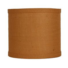 an orange lamp shade is shown against a white background and it has a light brown fabric covering