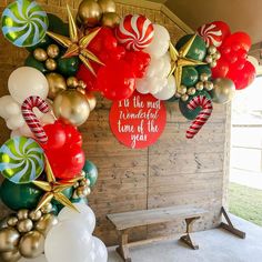 the balloon arch is decorated with red, white and green candy canes on it