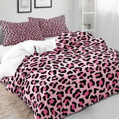 a bed with pink and black leopard print on it