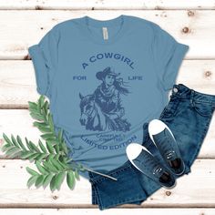 Our A Cowgirl for life t-shirt, is the perfect blend of style and western charm! Whether you're out on the ranch, riding your favorite horse, or simply rocking a casual yet chic look, this t-shirt is a must-have addition to your wardrobe. Do your t-shirts fail to keep up with your active, on-the-go lifestyle? Are you constantly tugging at your shirt or dealing with it shrinking in the wash can be a real drag, especially when you're out exploring or busy with errands. Our Bella & Canvas Unisex t- Country Style Short Sleeve T-shirt For Ranch, Country Style T-shirt For Rodeo In Spring, Fall Ranch Crew Neck T-shirt, Western Style T-shirt For Spring Ranch, Relaxed Fit Western T-shirt For Ranch, Fitted Casual T-shirt For Western-themed Events, Casual Fitted T-shirt For Western-themed Events, Western Style Relaxed Fit T-shirt For Ranch, Casual Cotton T-shirt For Western-themed Events