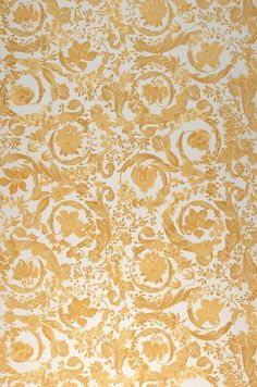 an old wallpaper with gold and white designs