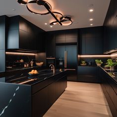 a modern kitchen with black cabinets and marble counter tops, along with an island in the middle