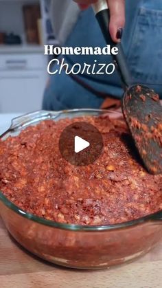 a person mixing food in a bowl with a spoon and the words homemade chorizzo written on it