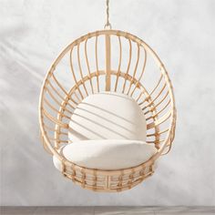 a hanging chair with two pillows in it and a white pillow on the back ground