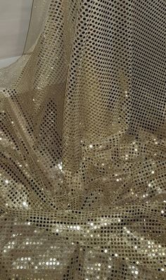 gold sequins are covering the sheer fabric