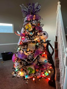 a decorated christmas tree in the shape of a jack skellingy and minnie mouse