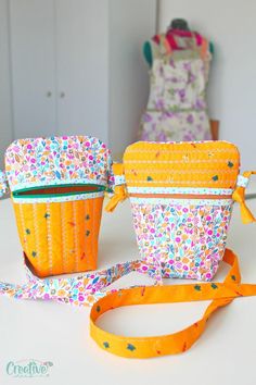 two small purses sitting on top of a table