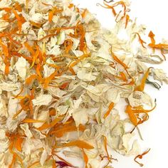 a pile of shredded white and orange flowers