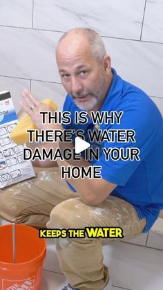 a man sitting on the floor with a calculator in his lap and texting, this is why there's water damage in your home