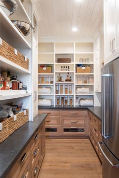 an organized kitchen with wooden cabinets and stainless steel appliances, along with lots of storage space