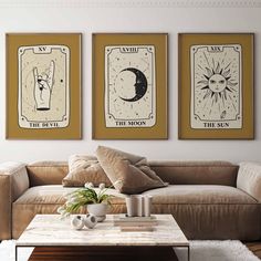 three sun and moon posters on the wall above a couch