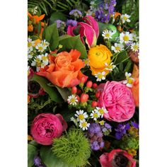 an arrangement of colorful flowers and greenery