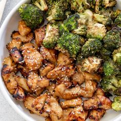 chicken and broccoli with sesame seeds in a bowl