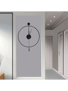 an image of a clock on the wall next to a door and vase with flowers in it