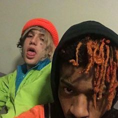 two young men with dreadlocks are posing for the camera