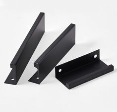 two black metal brackets sitting next to each other